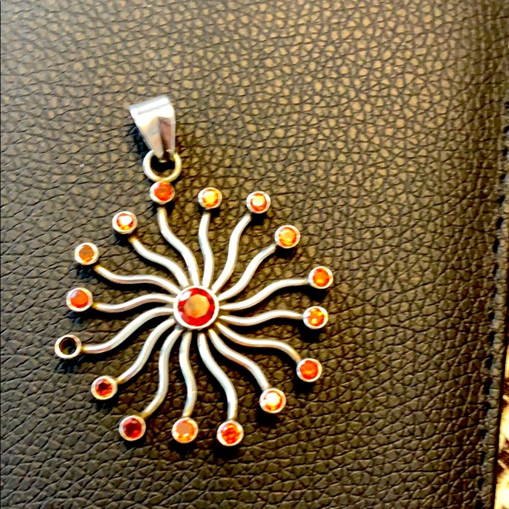 Sterling silver sun pendant with garnet stones